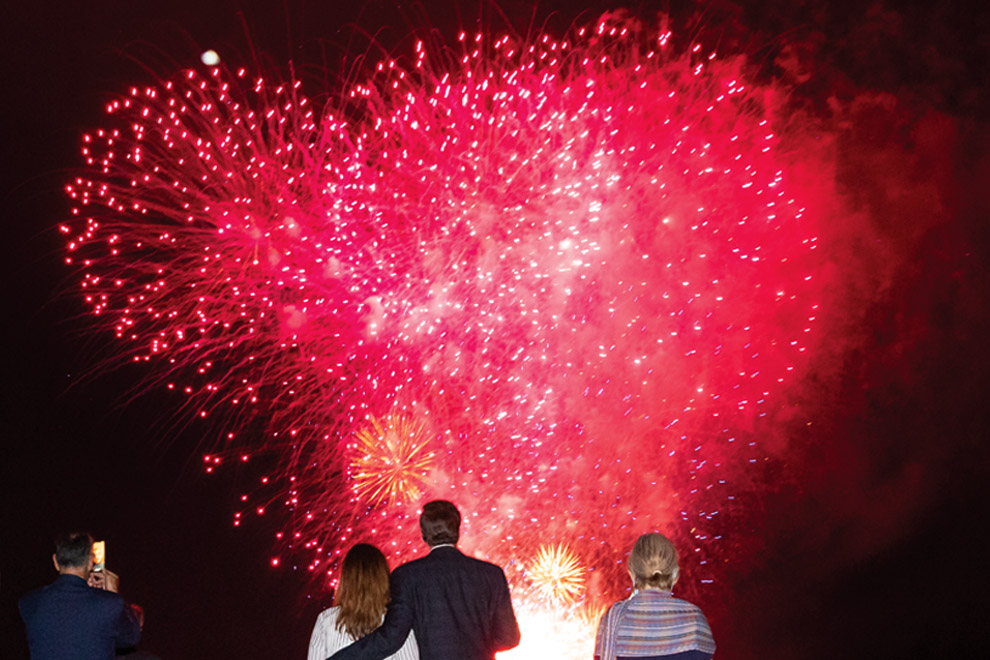 A group of people watching fireworks