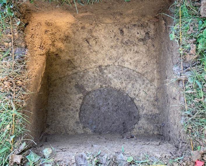 At ground level, archaeologists exposed a dark circle indicating the remnants of a timber post, likely part of an outbuilding, animal enclosure, or fence line constructed by Union Farm&rsquo;s enslaved residents.