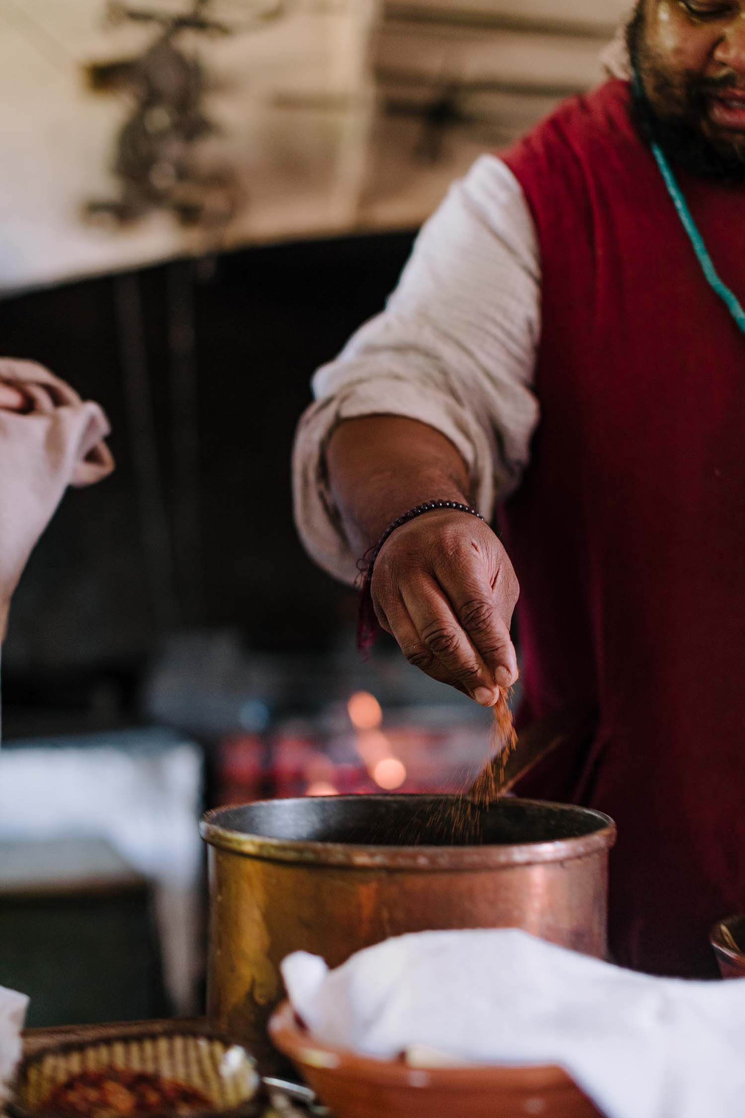 Michael Twitty adds spices to a pot